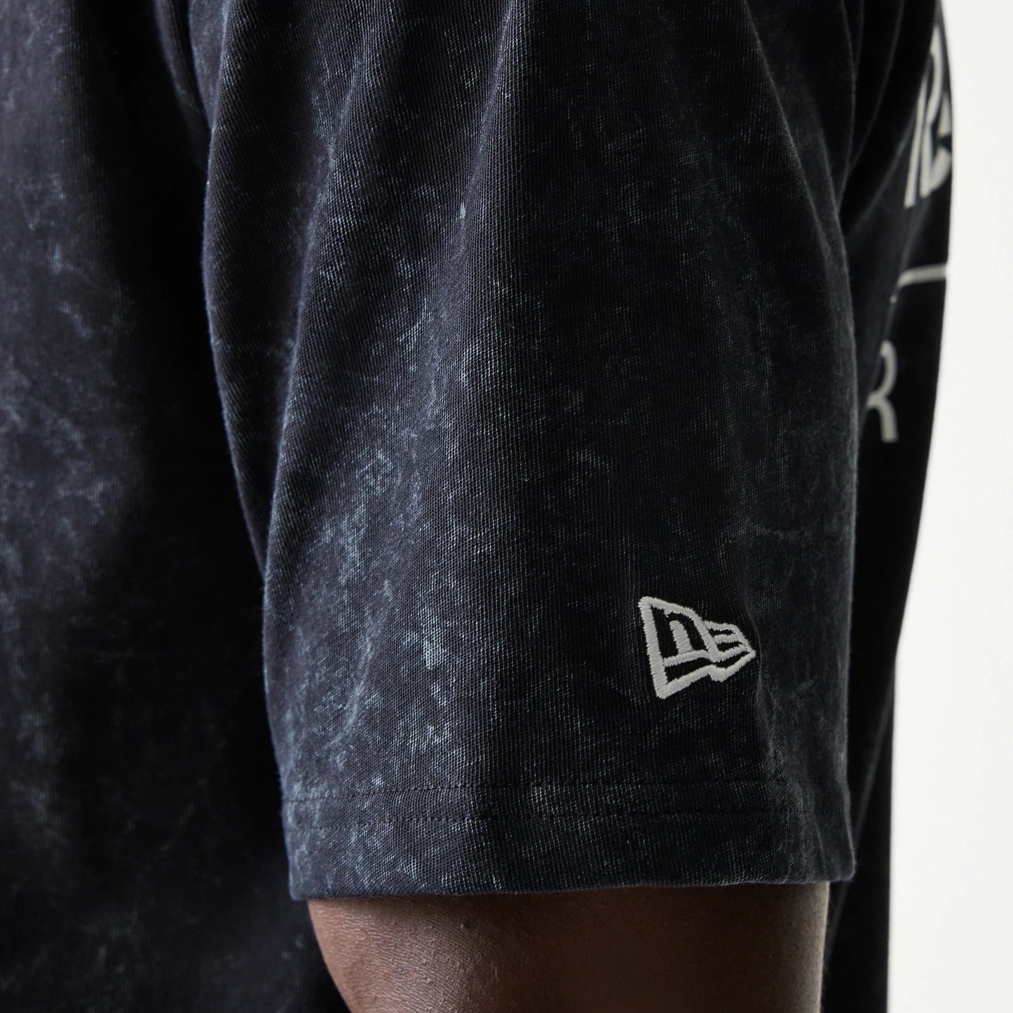 The model is wearing this Red Bull Racing Linear Graphic Oversized T-Shirt in black. 5