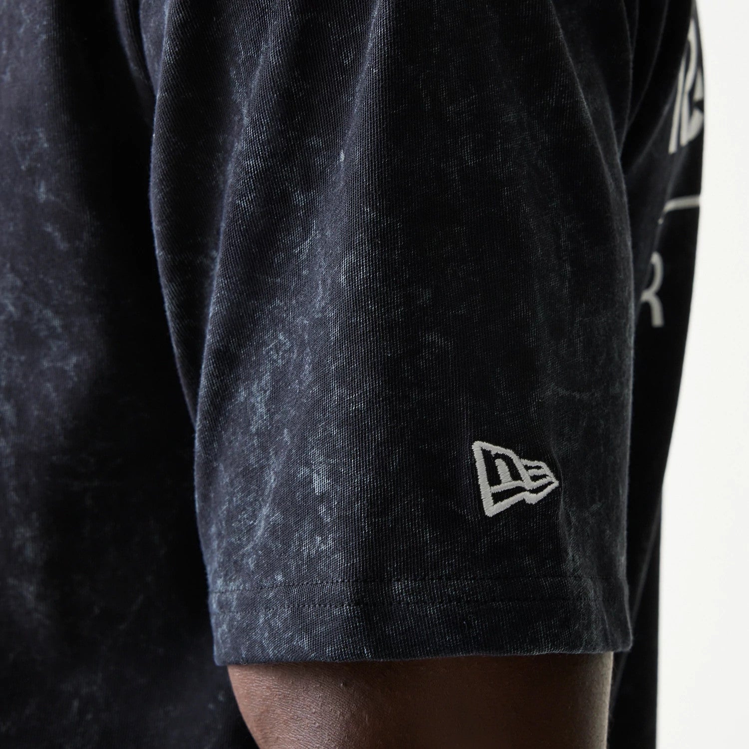 The model is wearing this Red Bull Racing Linear Graphic Oversized T-Shirt in black. 5