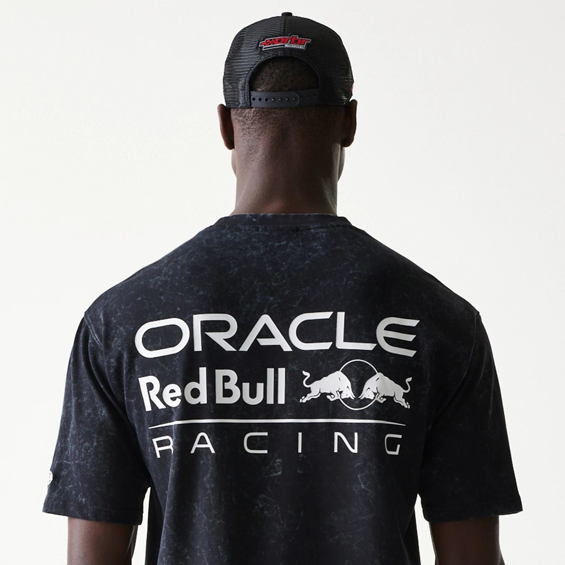 The model is wearing this Red Bull Racing Linear Graphic Oversized T-Shirt in black. 7