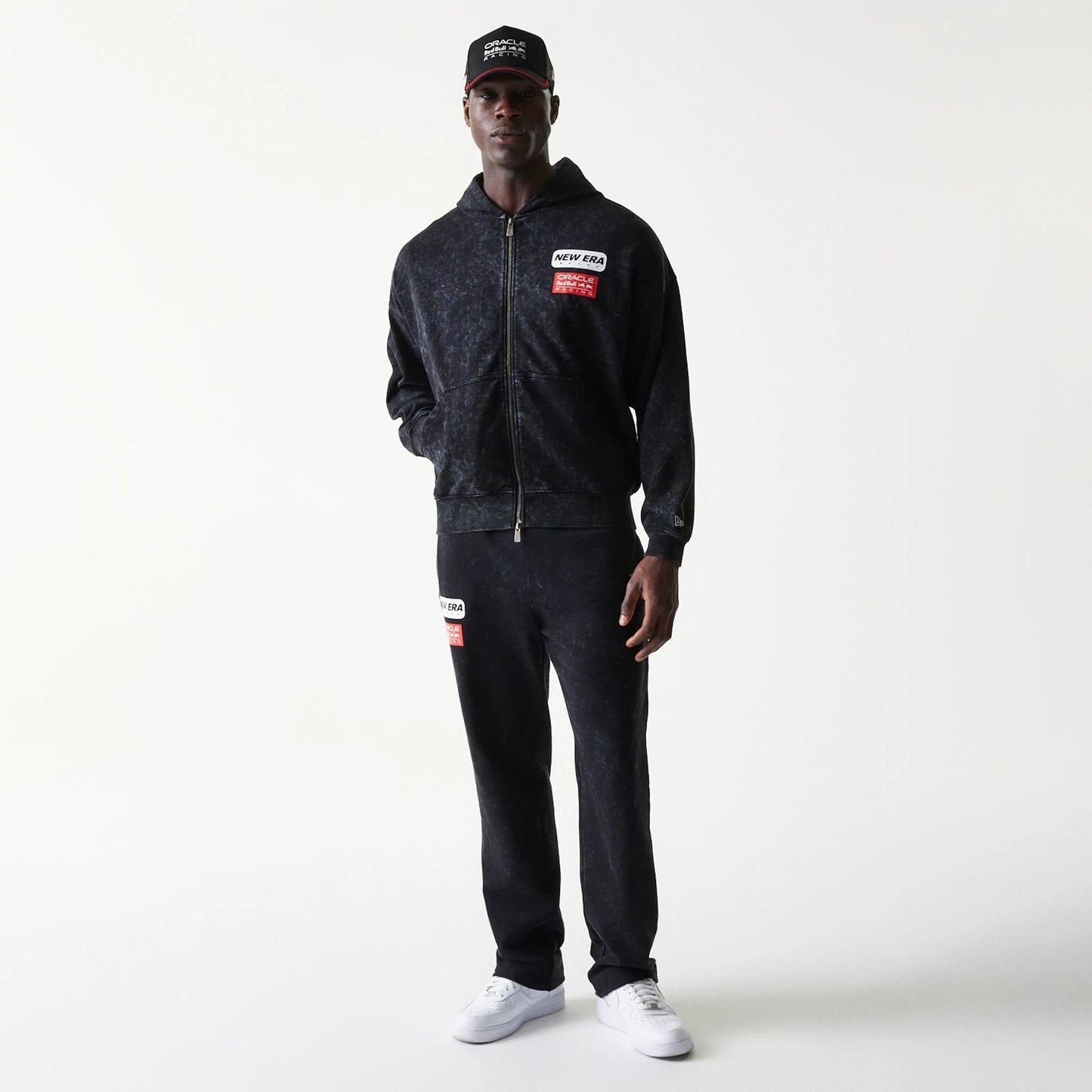 The model is wearing this Red Bull Racing Dropped Shoulder Full Zip Hoodie in black. 8