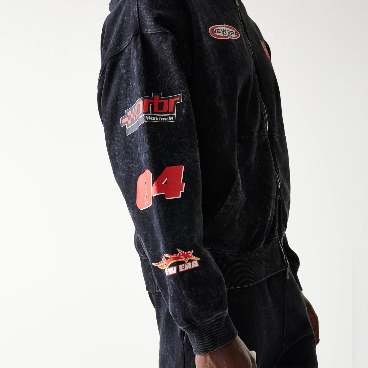 The model is wearing this Red Bull Racing Graphic Dropped Shoulder Full Zip Hoodie in black. 3