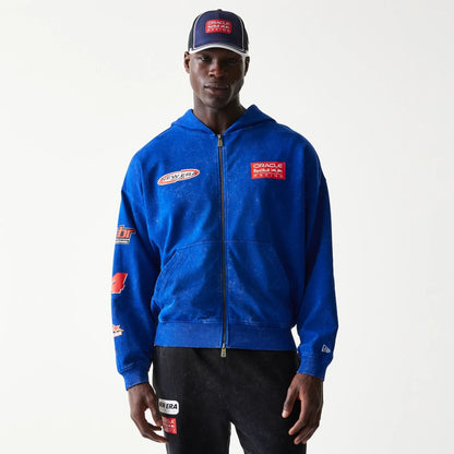 The model is wearing this Red Bull Racing Graphic Dropped Shoulder Full Zip Hoodie in blue. 1