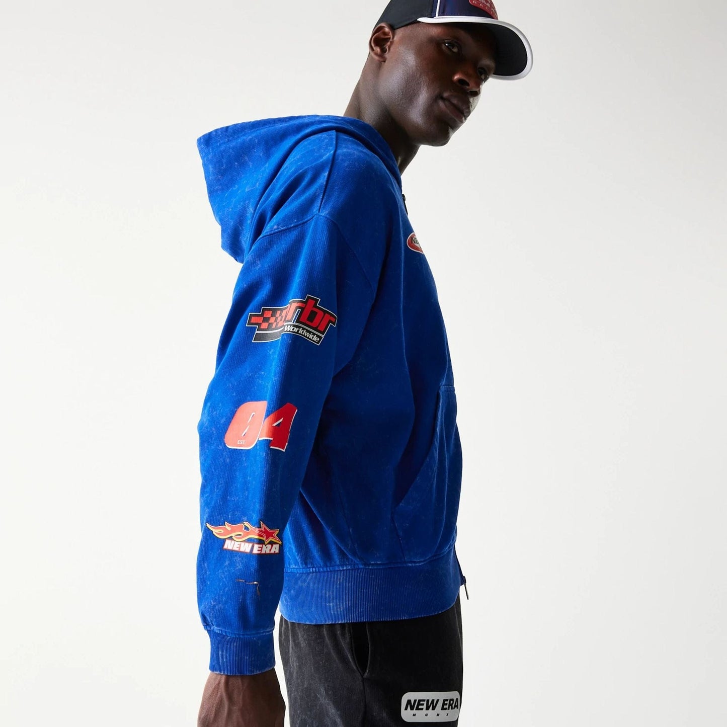 The model is wearing this Red Bull Racing Graphic Dropped Shoulder Full Zip Hoodie in blue. 6