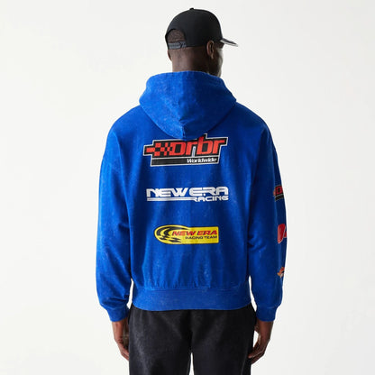 The model is wearing this Red Bull Racing Graphic Dropped Shoulder Full Zip Hoodie in blue. 2
