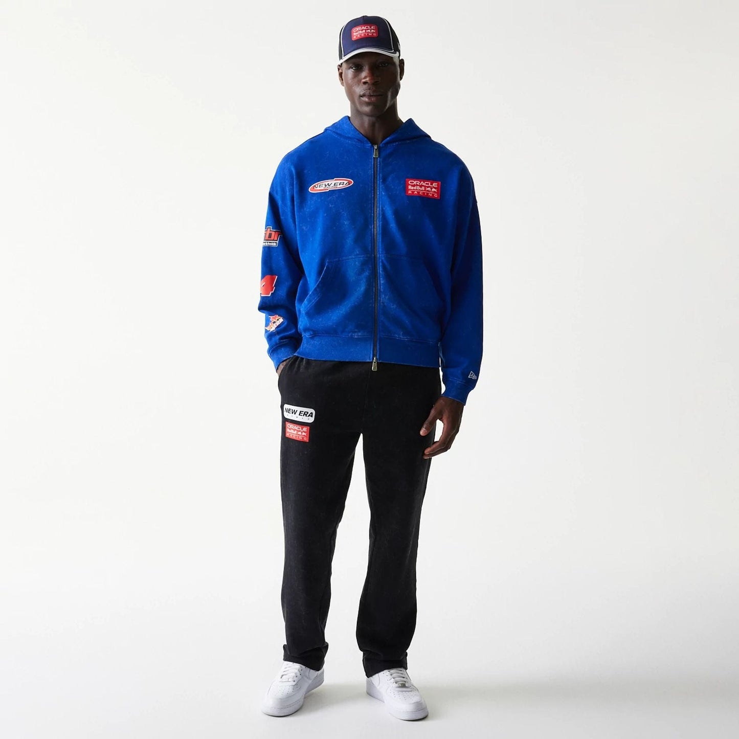 The model is wearing this Red Bull Racing Graphic Dropped Shoulder Full Zip Hoodie in blue. 8