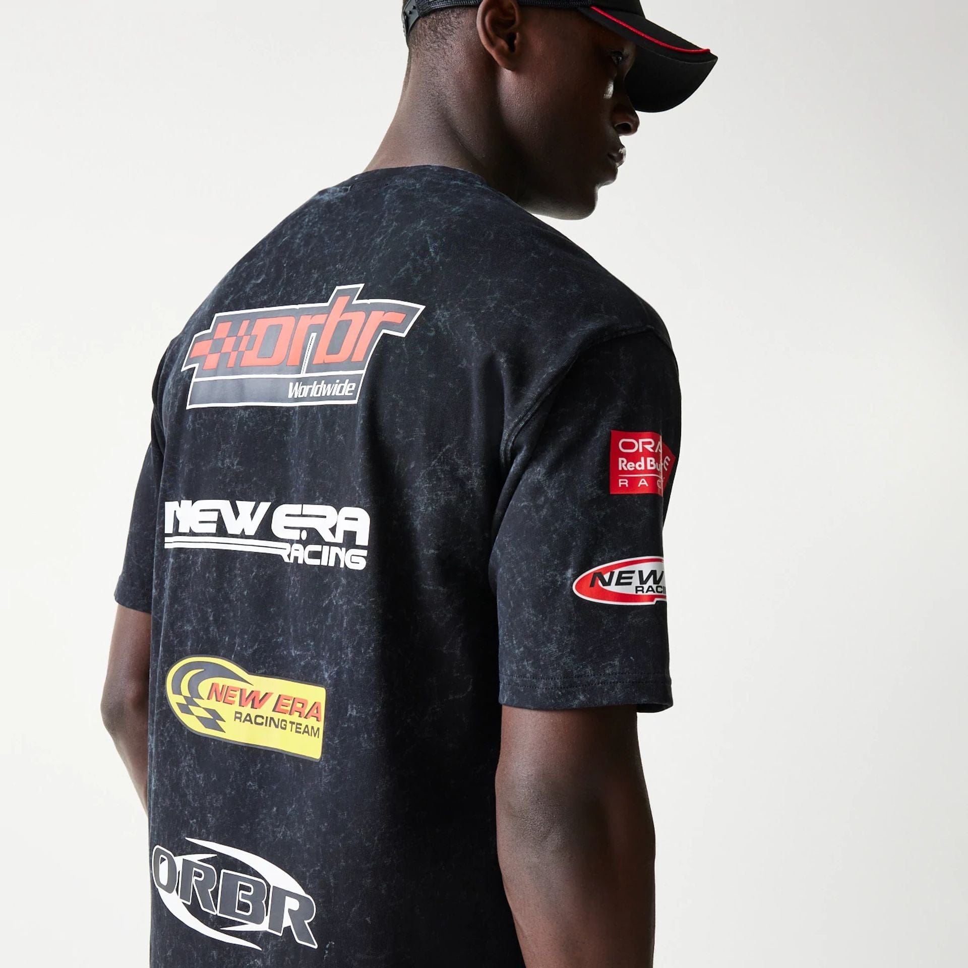 The model is wearing this Red Bull Racing Graphic Oversized T-Shirt in black. 6