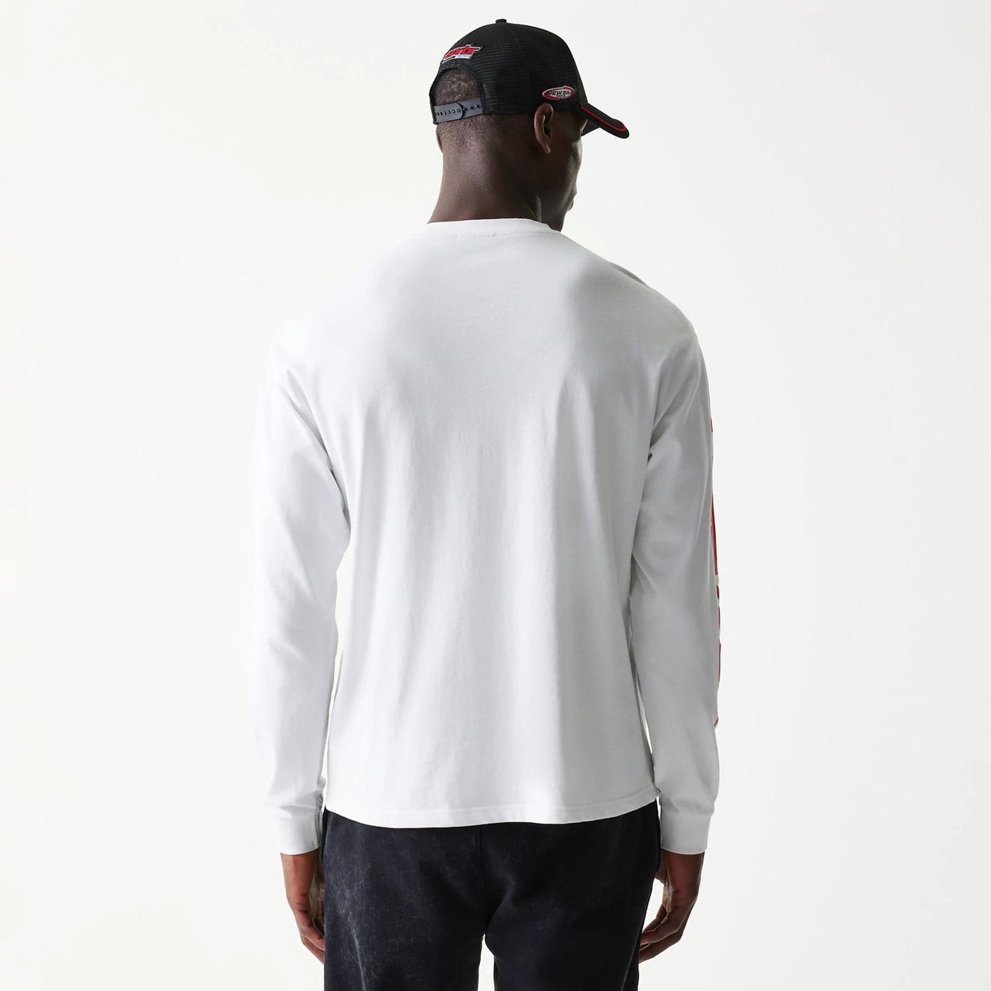 The model is wearing this Red Bull Racing Graphic Long Sleeve T-Shirt in white. 2