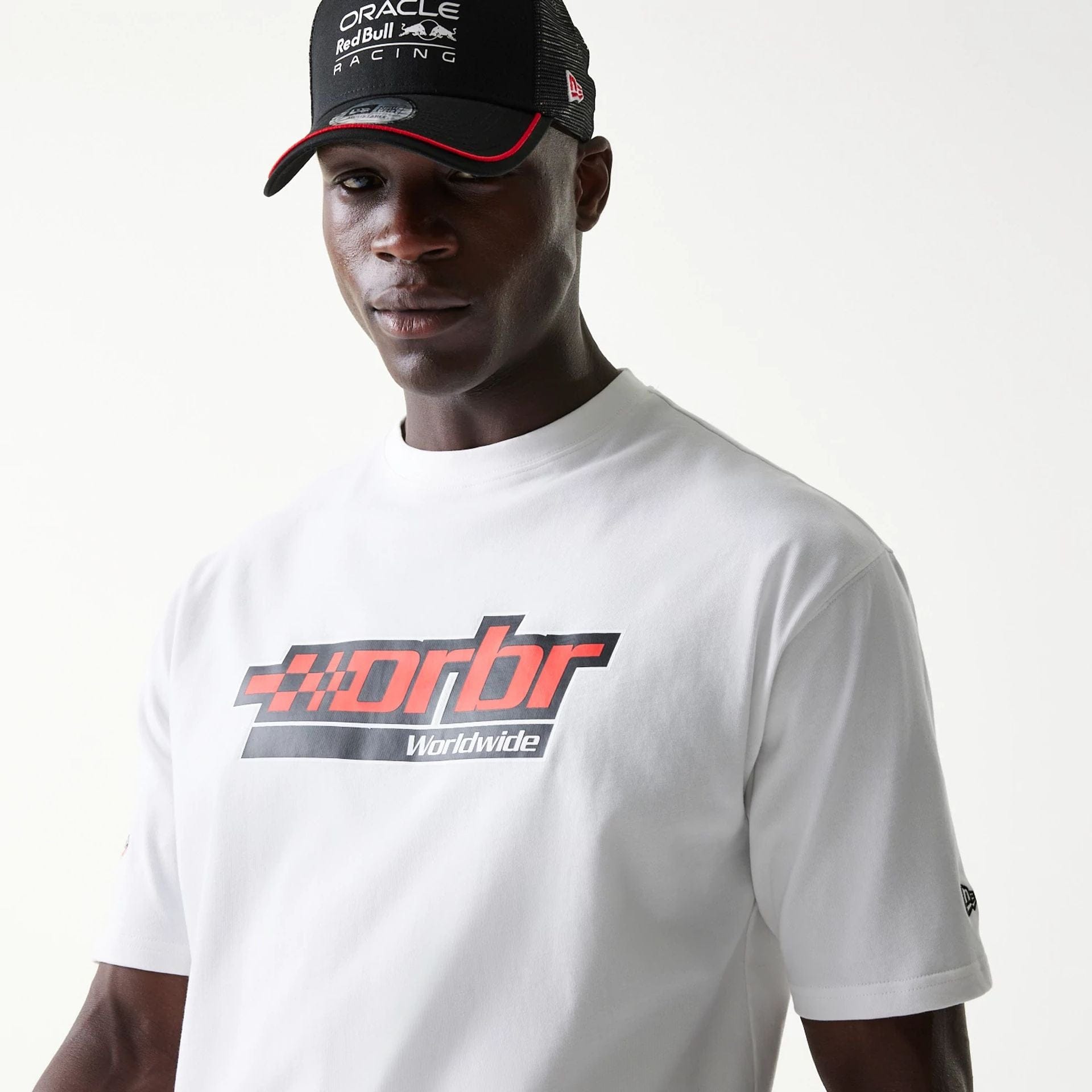 The model is wearing this Red Bull Racing Graphic Oversized T-Shirt in white. 3