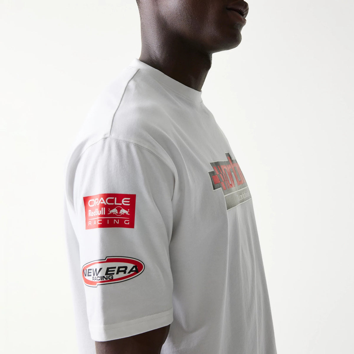 The model is wearing this Red Bull Racing Graphic Oversized T-Shirt in white. 5