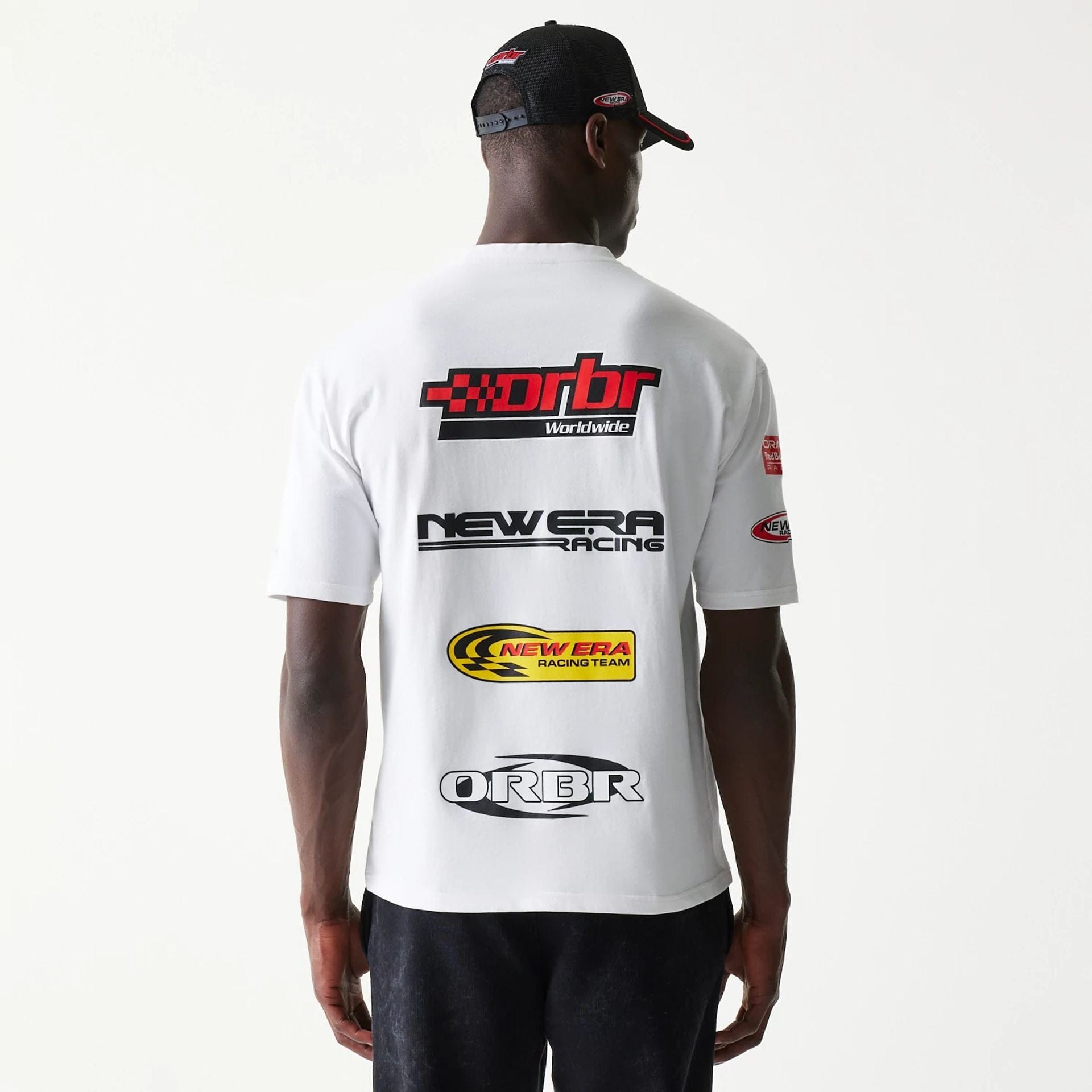 The model is wearing this Red Bull Racing Graphic Oversized T-Shirt in white. 2
