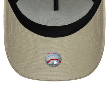 New York Yankees MLB Light Beige New Era 9FORTY A-Frame Trucker Cap, inside view showing a black sweatband, grey undervisor, and a baseball graphic sticker on the light beige curved visor.