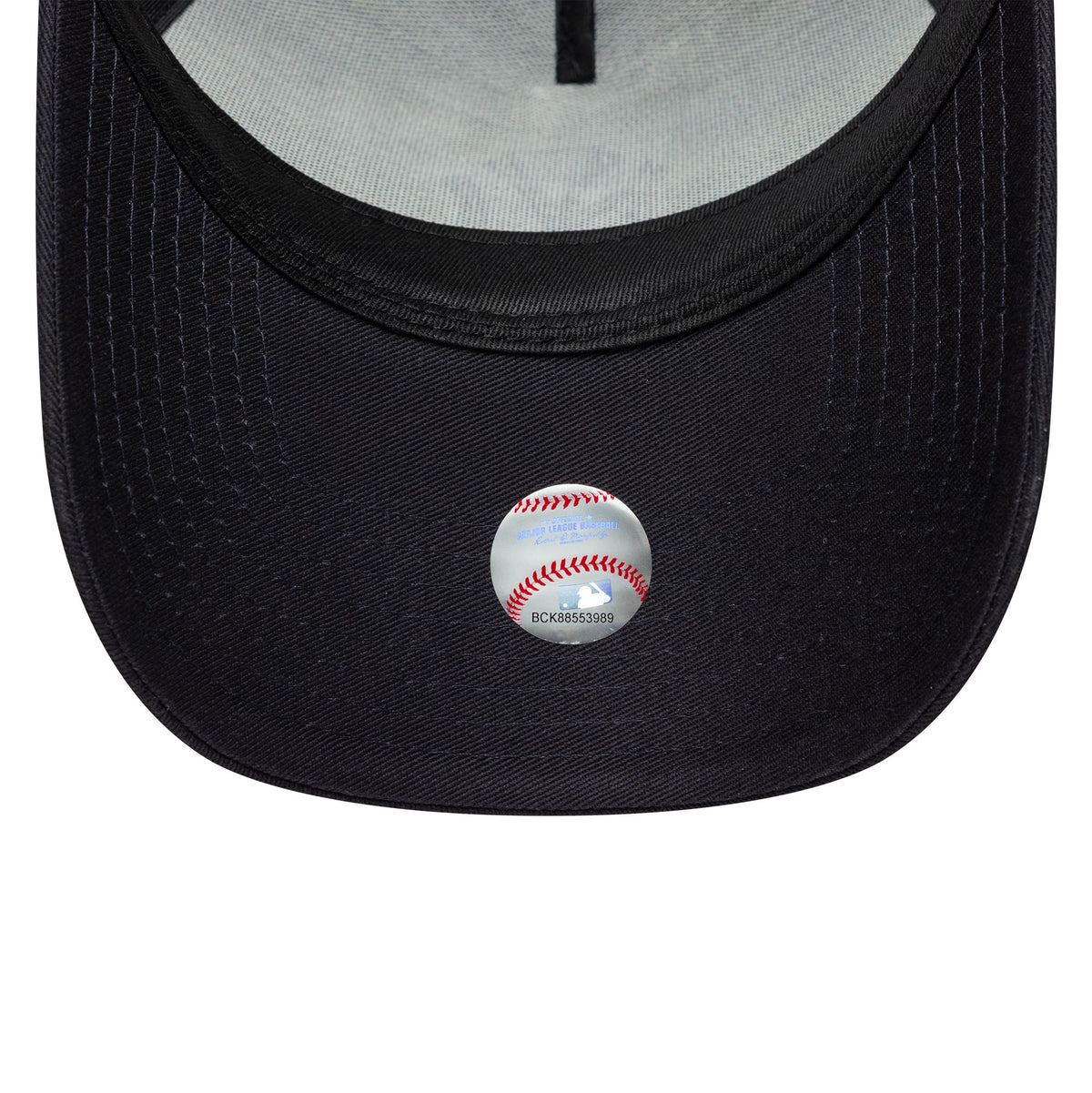 New York Yankees MLB Outline Navy New Era 9FORTY E-Frame Trucker Cap, inside view showing the grey undervisor with twill taping along the seams and a reflective MLB sticker on the navy curved visor.
