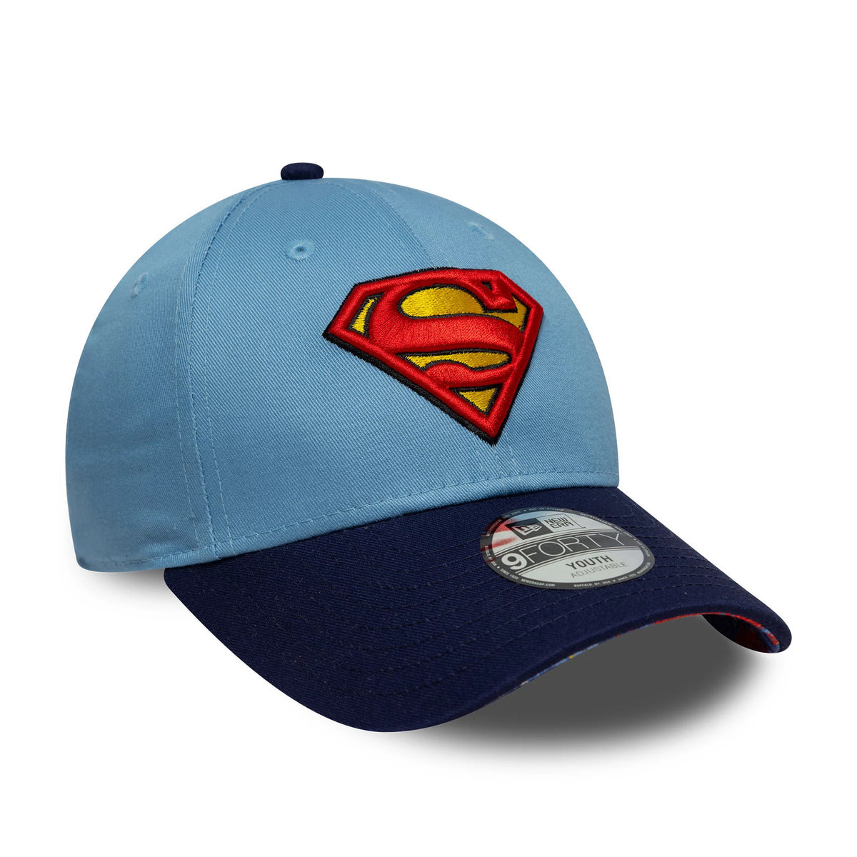Youth DC Superman Pastel Blue New Era 9FORTY Cap, three-quarter view showing the raised red and yellow Superman logo on the front panel, curved navy visor with a 9FORTY size sticker, and a matching pastel blue top button.