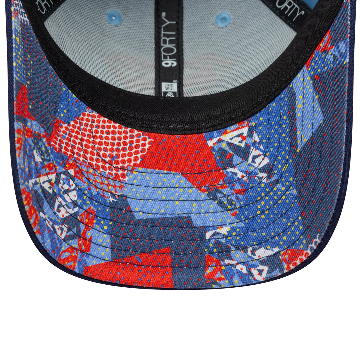 Youth DC Superman Pastel Blue New Era 9FORTY Cap, inside view showing the colourful abstract pattern on the undervisor, black sweatband with 9FORTY branding, and two blue eyelets on the structured crown.