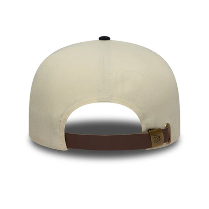 New Era Outdoor Graphic Light Beige 19TWENTY Adjustable Cap, rear view showing the light beige crown with a black top button and a brown leather strap featuring a bronze buckle embossed with the New Era logo.
