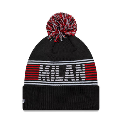 New Era AC Milan Black Bobble Knit Beanie Hat, front view showing the AC Milan text in white and red on a black background with red and white striped accents and a multicoloured bobble on top, New Era flag logo on the cuff.