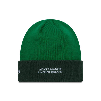 New Era Ryder Cup 2027 Adare Manor Green Cuff Knit Beanie Cap, front view showing the white embroidered Adare Manor Limerick Ireland text on the dark green cuff and the New Era flag logo on the left side.