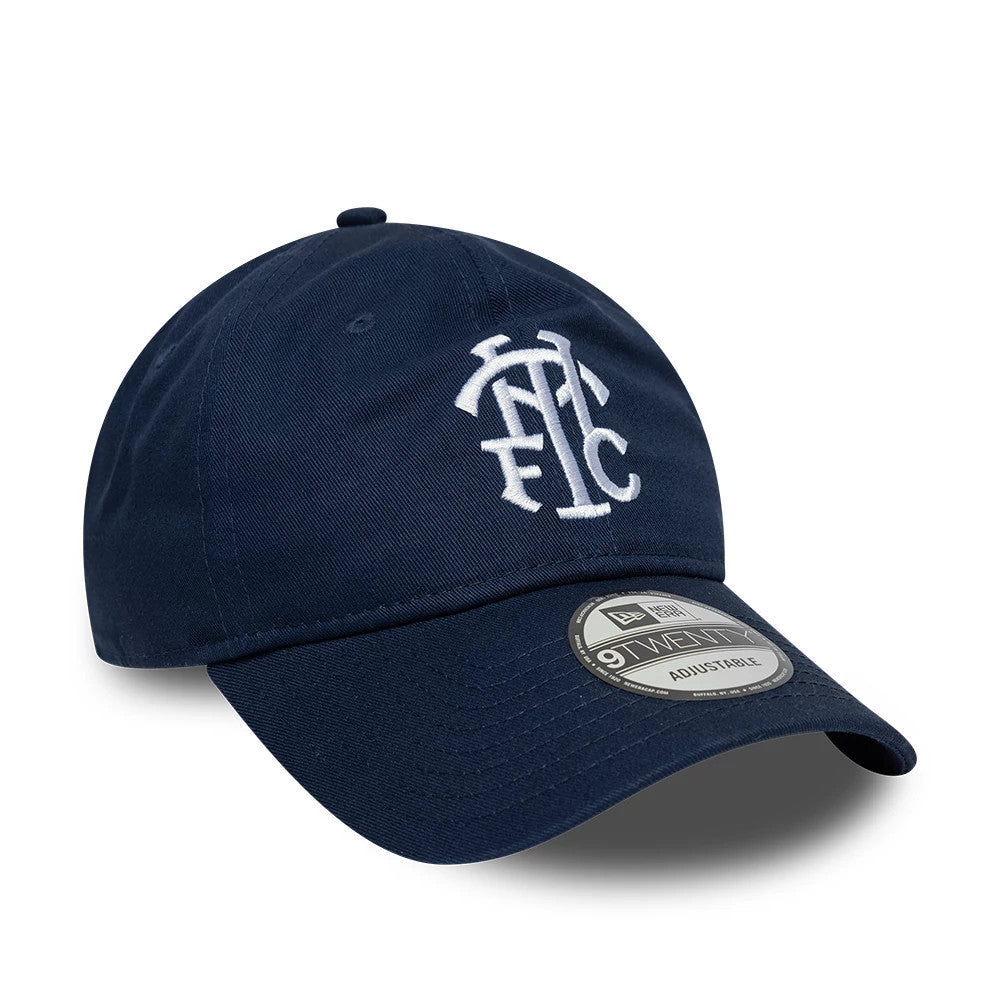 Tottenham Hotspur FC Monogram Navy New Era 9TWENTY Adjustable Cap, three-quarter view showing the white embroidered monogram logo on the front panel, curved navy visor with an official 9TWENTY size sticker.