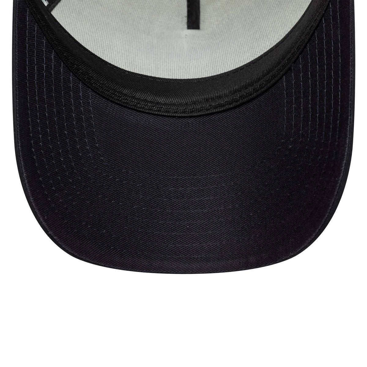 Tottenham Hotspur FC Puff Wordmark Navy New Era 9FORTY A-Frame Trucker Cap, inside view showing a black undervisor, light-grey fabric sweatband, and black interior taping with a partially arch shape of the cap's crown.