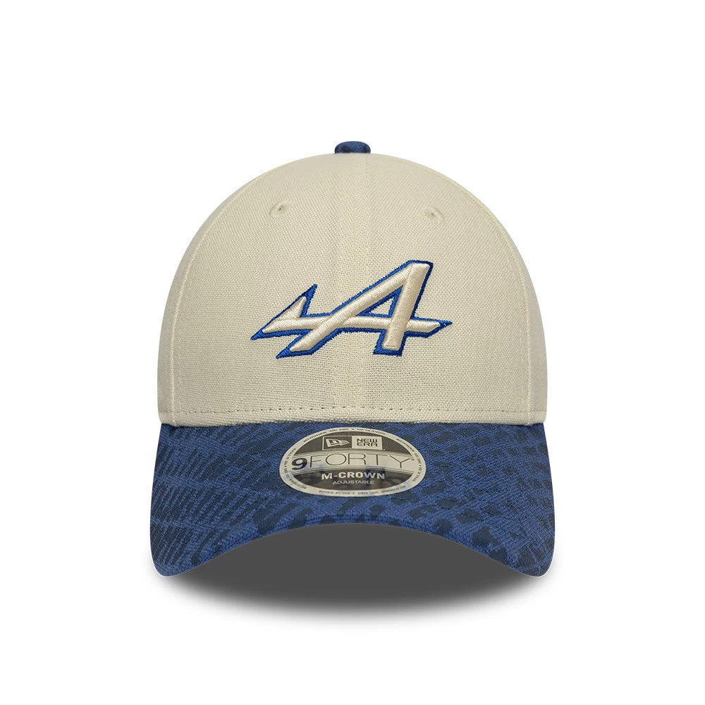 Alpine Racing Heritage Cream & Dark Blue New Era 9FORTY M-Crown Cap, front view showing the blue and cream embroidered logo on the cream front panel, with a dark blue patterned curved visor and a 9FORTY size sticker.