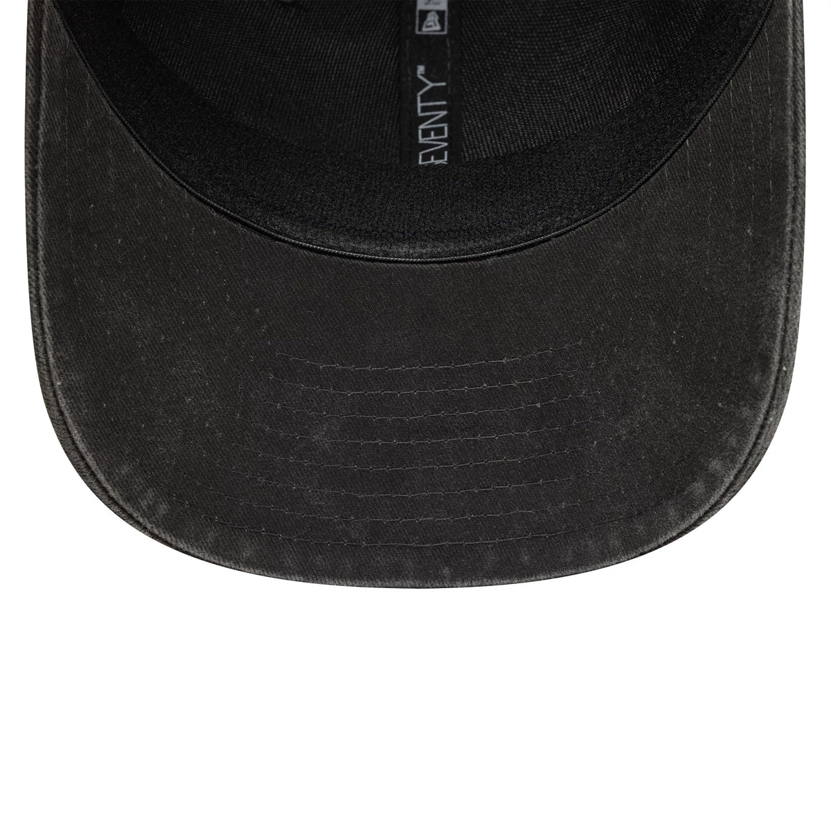 Moto Guzzi Washed Black New Era 9SEVENTY Stretch Snap Cap, inside view showing a black undervisor with detailed stitching, a black sweatband, and taping featuring the New Era logo and 9SEVENTY branding.