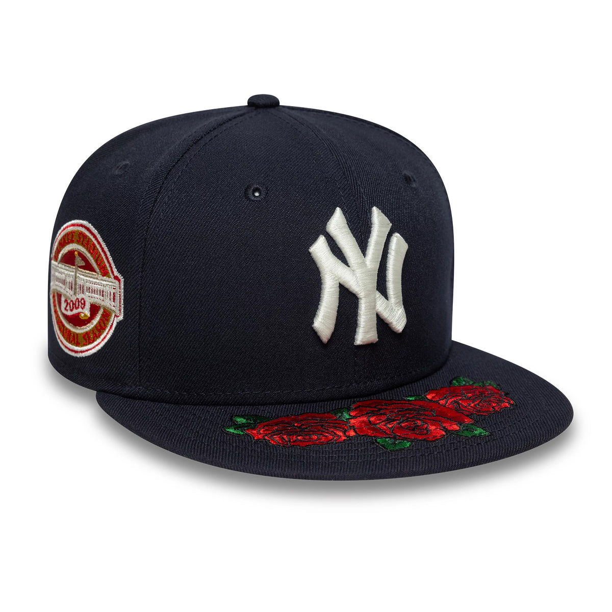 New York Yankees MLB Cooperstown Floral Navy New Era 59FIFTY Fitted Cap, three-quarter view showing the white embroidered NY logo on the front panel, red floral embroidery on the visor, and a Yankee Stadium 2009 patch on the right side.