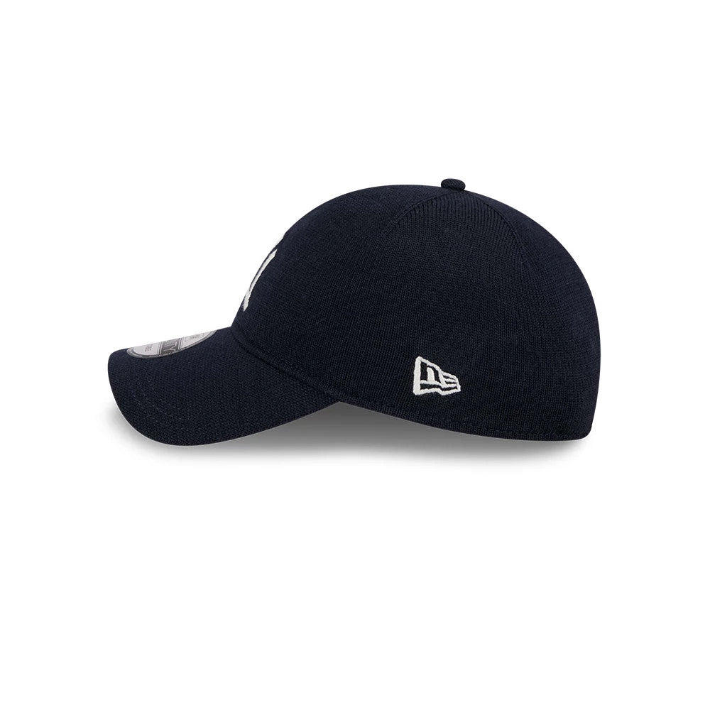 New York Yankees MLB Merino Wool Navy New Era 9TWENTY Adjustable Cap, side view showing the white embroidered New Era flag logo on the left side of the soft navy crown, with a curved visor and 9TWENTY size sticker.