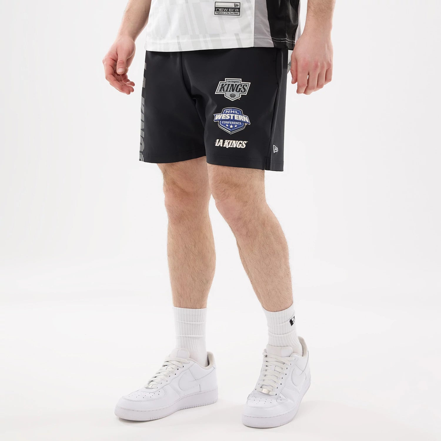 The model is wearing this NHL Match LA Kings Oversized Shorts in black. 1