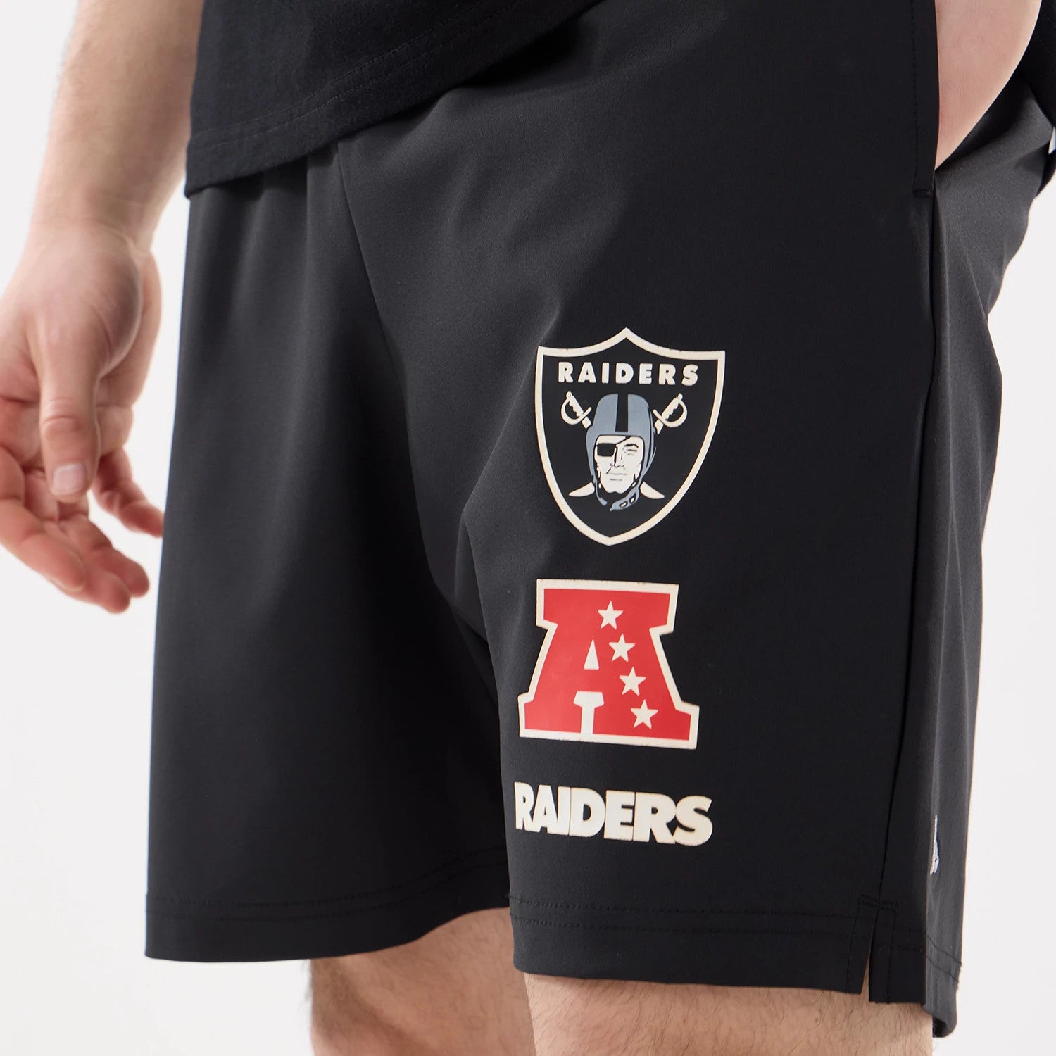 The model is wearing this NFL Match Las Vegas Raiders Oversized Shorts in black. 3