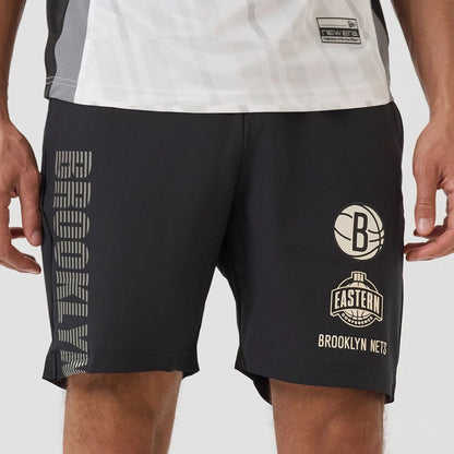 The model is wearing this NBA Match Brooklyn Nets Oversized Shorts in black. 4