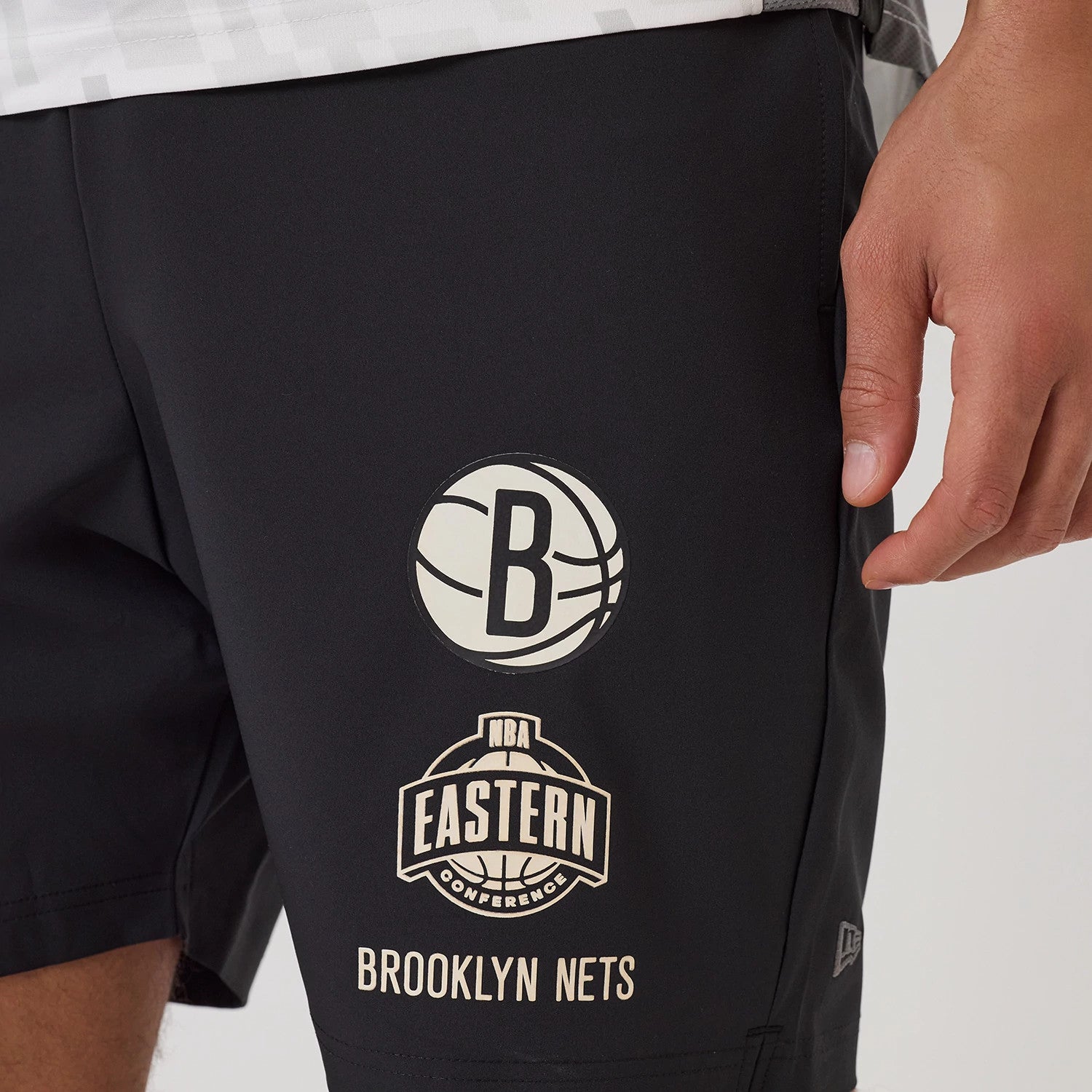 The model is wearing this NBA Match Brooklyn Nets Oversized Shorts in black. 3