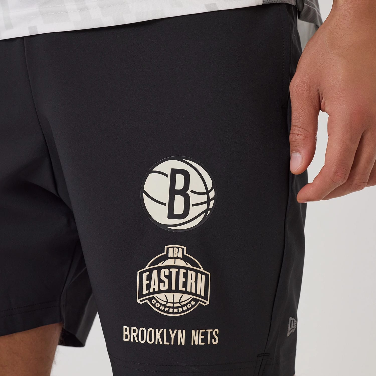 The model is wearing this NBA Match Brooklyn Nets Oversized Shorts in black. 3