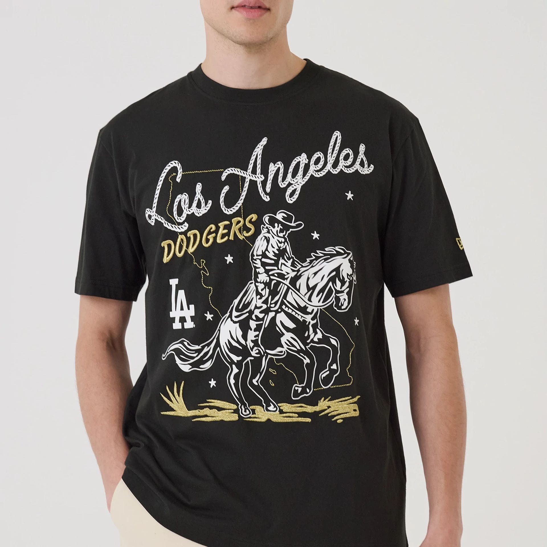 The model is wearing this MLB Cowboy Graphic LA Dodgers T-Shirt in black. 5
