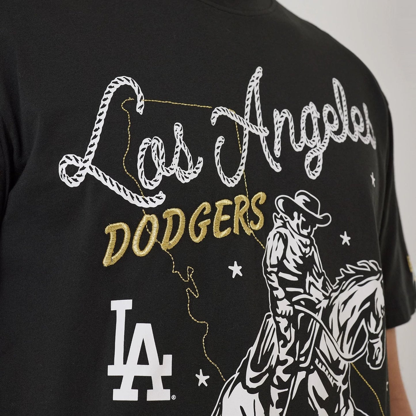 The model is wearing this MLB Cowboy Graphic LA Dodgers T-Shirt in black. 3