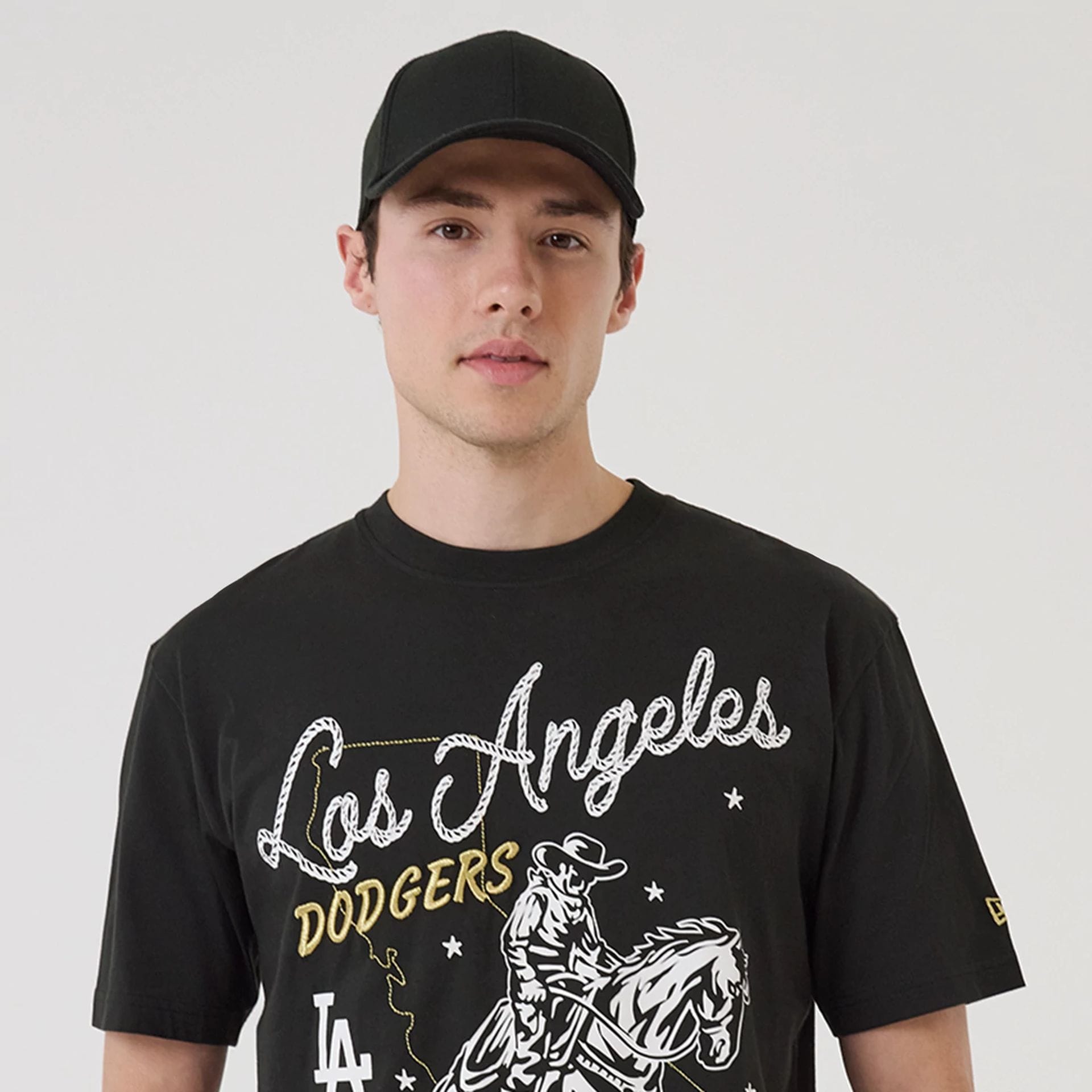 The model is wearing this MLB Cowboy Graphic LA Dodgers T-Shirt in black. 7