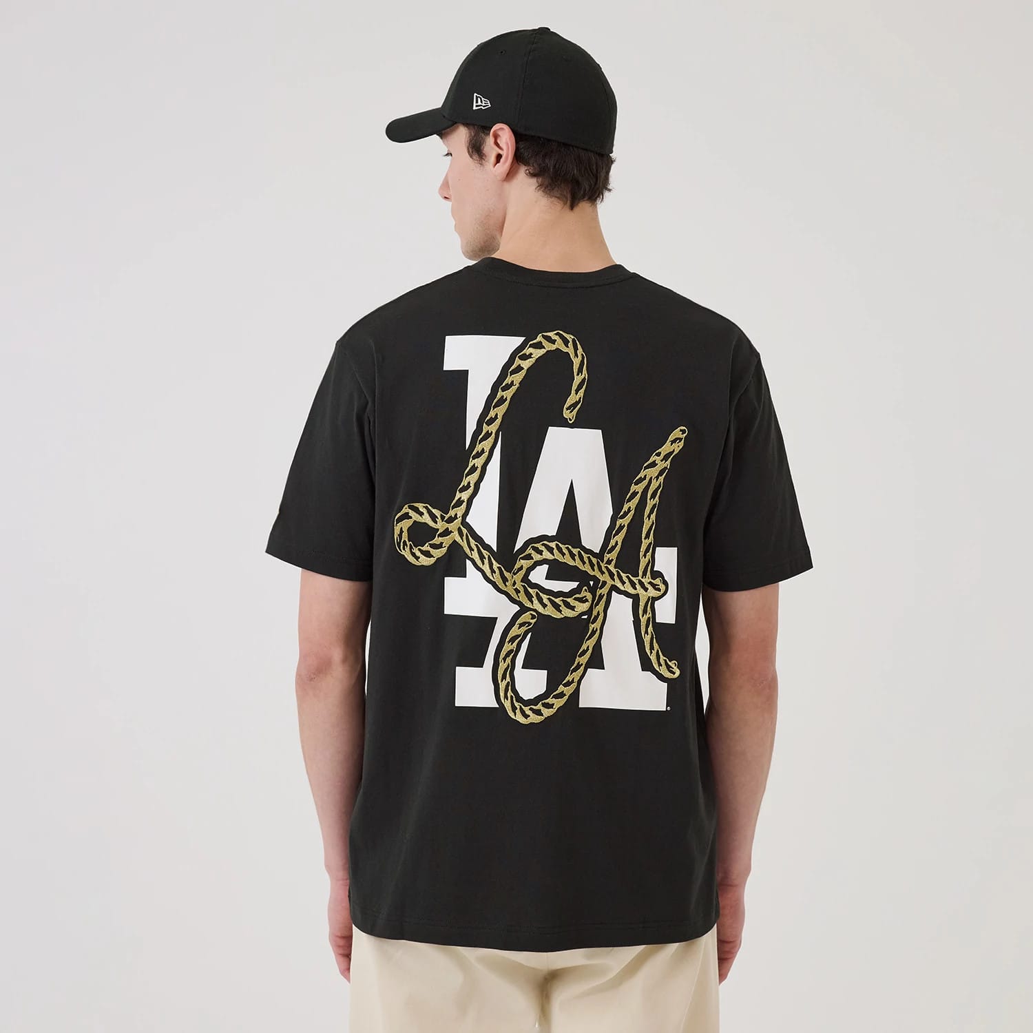 The model is wearing this MLB Cowboy Graphic LA Dodgers T-Shirt in black. 2