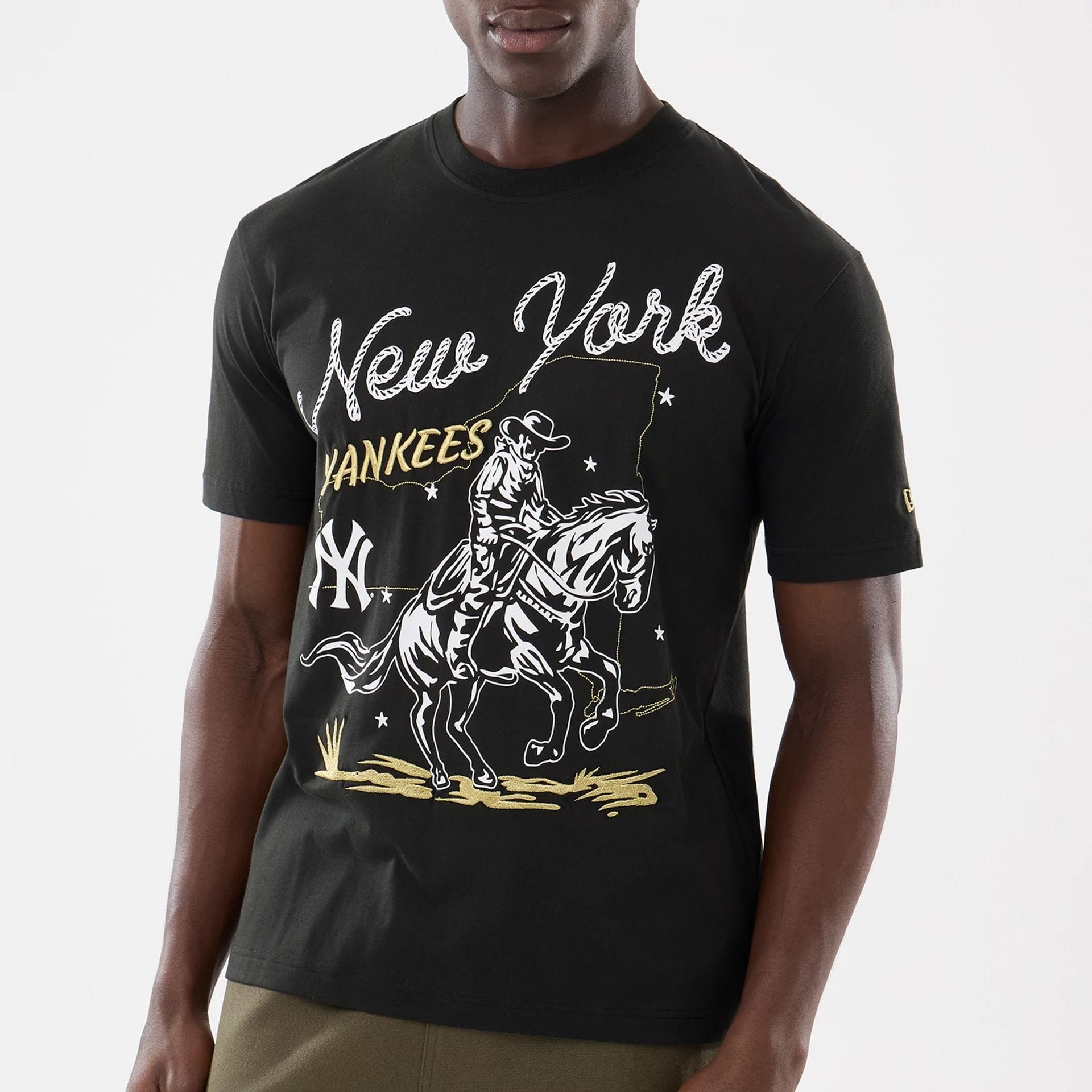 The model is wearing this MLB Cowboy Graphic New York Yankees T-Shirt in black. 3