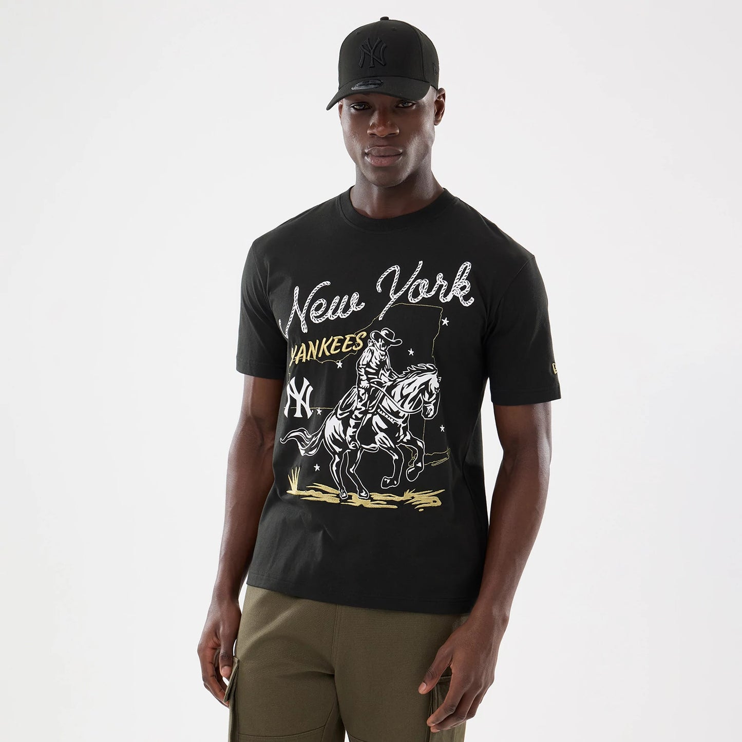 The model is wearing this MLB Cowboy Graphic New York Yankees T-Shirt in black. 1