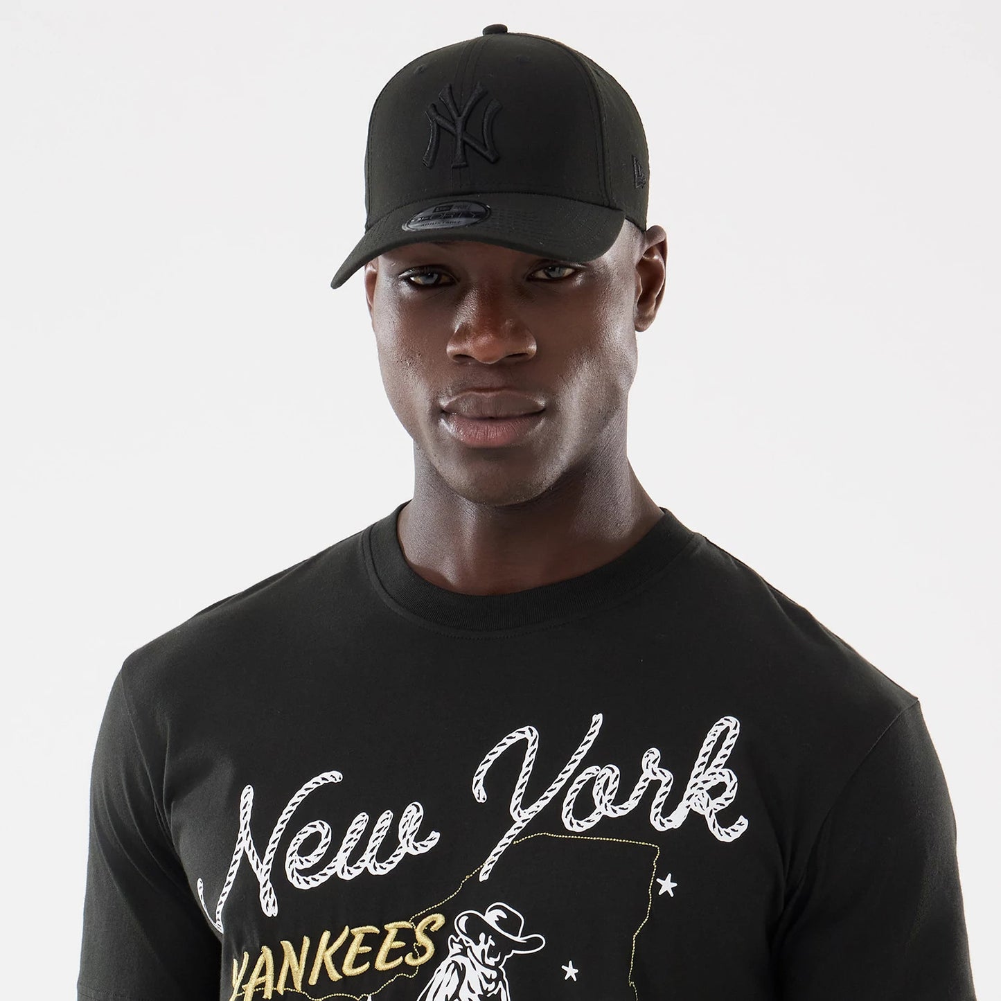 The model is wearing this MLB Cowboy Graphic New York Yankees T-Shirt in black. 6
