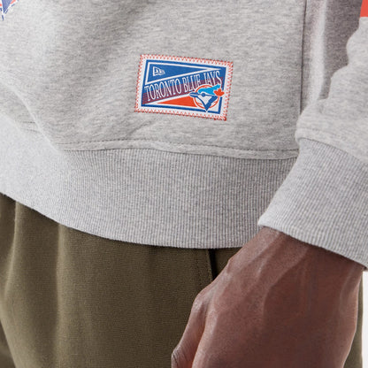 The model is wearing this MLB Sport Classic Toronto Blue Jays Crew Neck Sweater in grey. 4