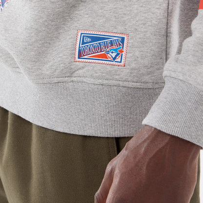 The model is wearing this MLB Sport Classic Toronto Blue Jays Crew Neck Sweater in grey. 4