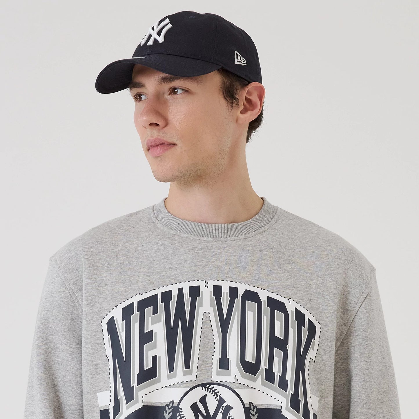 The model is wearing this MLB Sport Classic New York Yankees Crew Neck Sweater in grey. 6