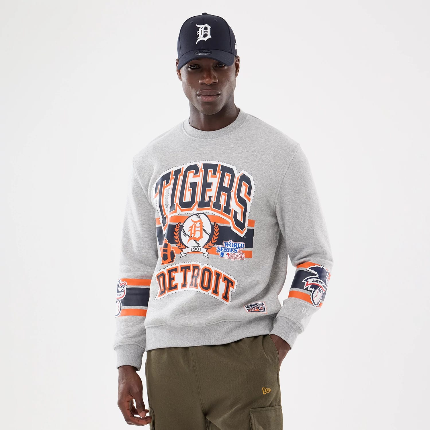 The model is wearing this MLB Sport Classic Detroit Tigers Crew Neck Sweater in grey. 1