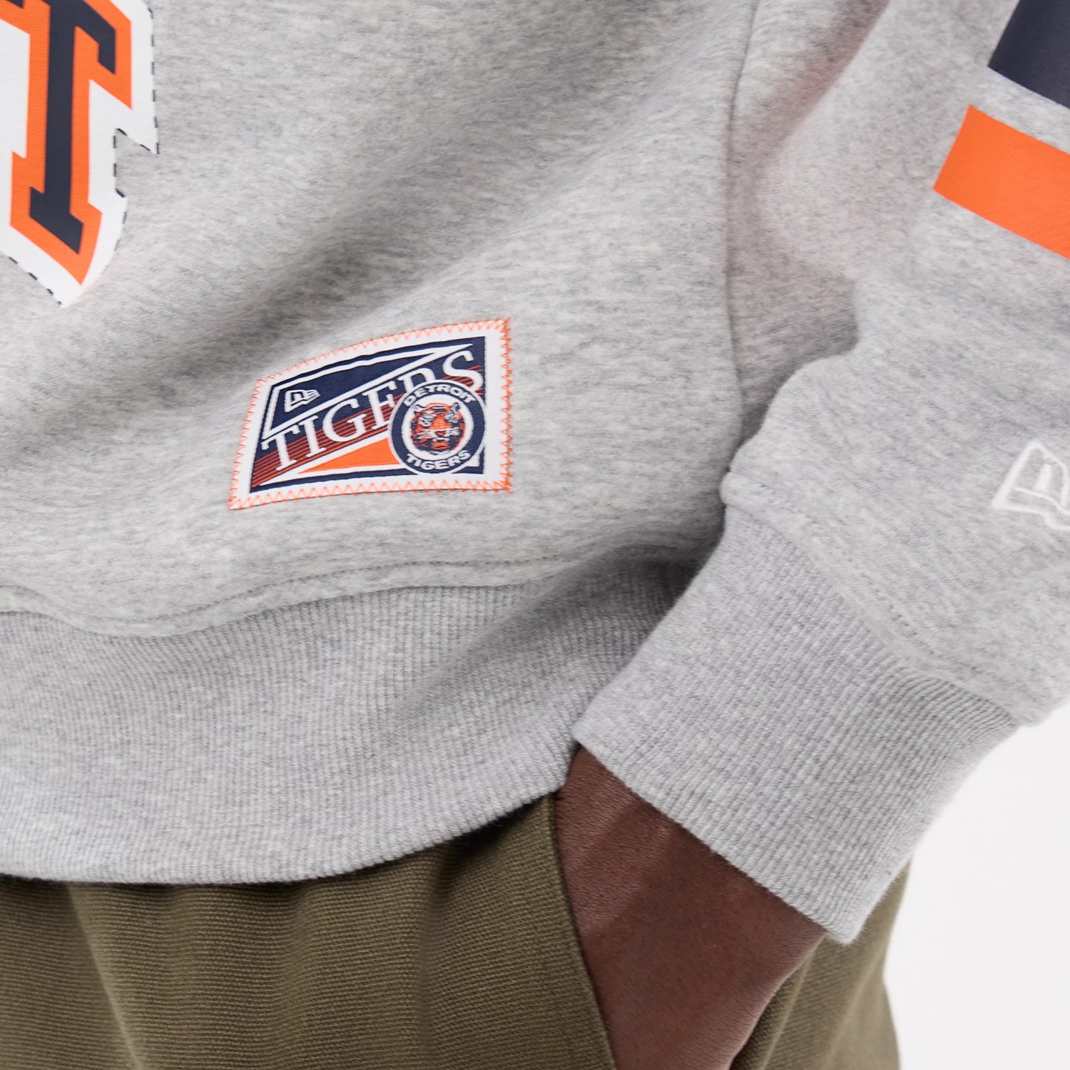 The model is wearing this MLB Sport Classic Detroit Tigers Crew Neck Sweater in grey. 4