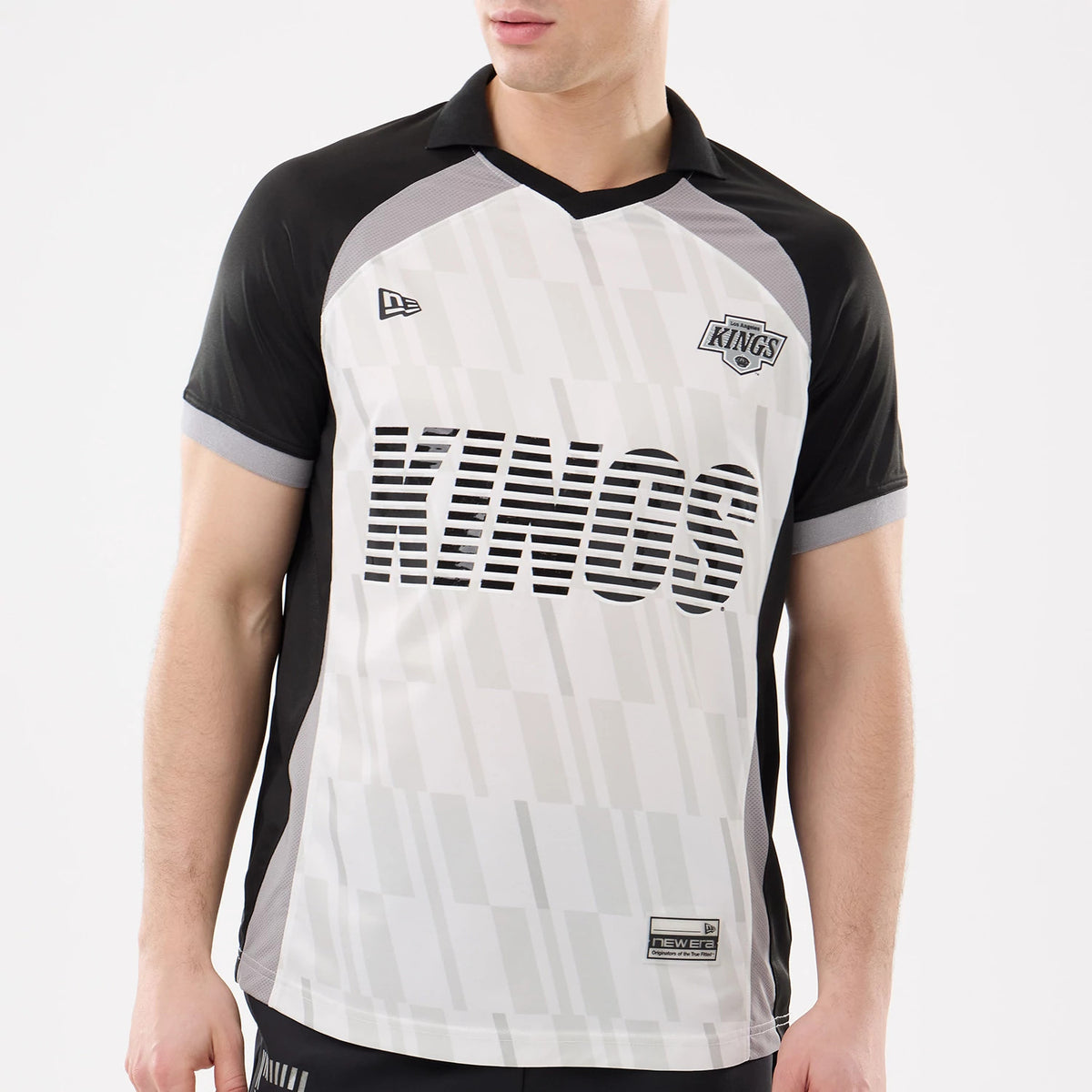New Era LA Kings NHL Match Black T-Shirt, front view on a model showcasing the KINGS lettering across the chest, an embroidered team logo on the left side, and the New Era logo on the opposite side against a monochrome background.