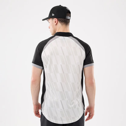 New Era LA Kings NHL Match Black T-Shirt, back view on-model featuring a distinctive grey patterned back panel, black and grey sleeves, and a black collar, paired with a black cap styled on the model.