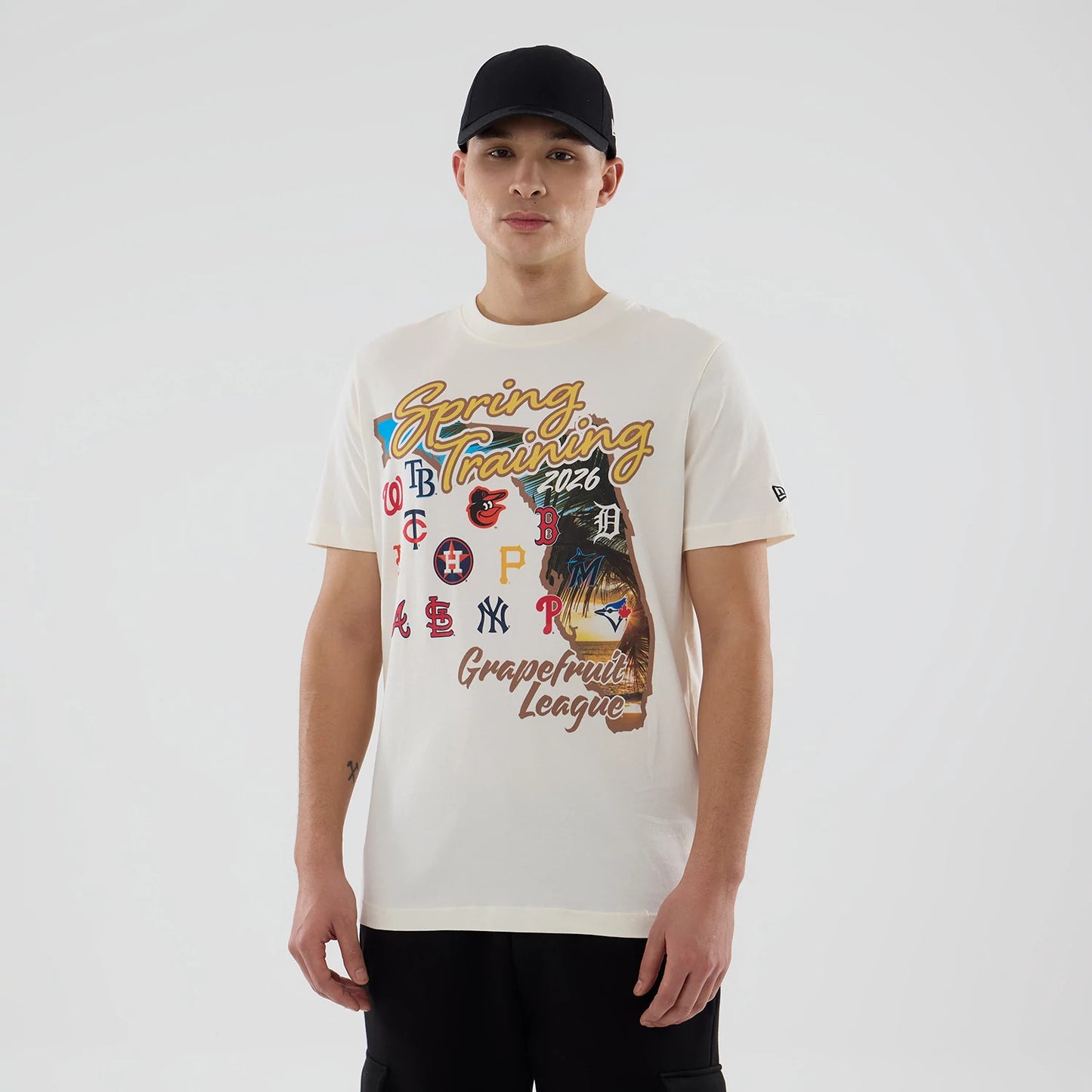The model is wearing this MLB Spring Training 2026 Grapefruit League Logo T-Shirt in Cream. 1