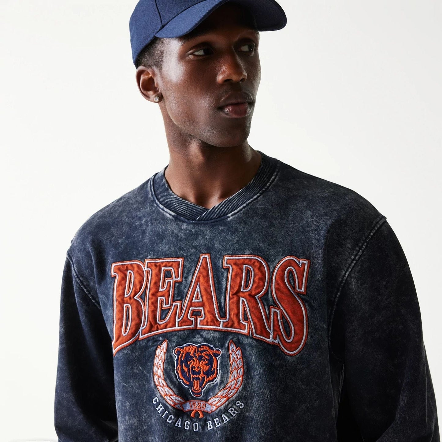 The model is wearing this NFL Chicago Bears Crew Neck Sweater in navy. 4