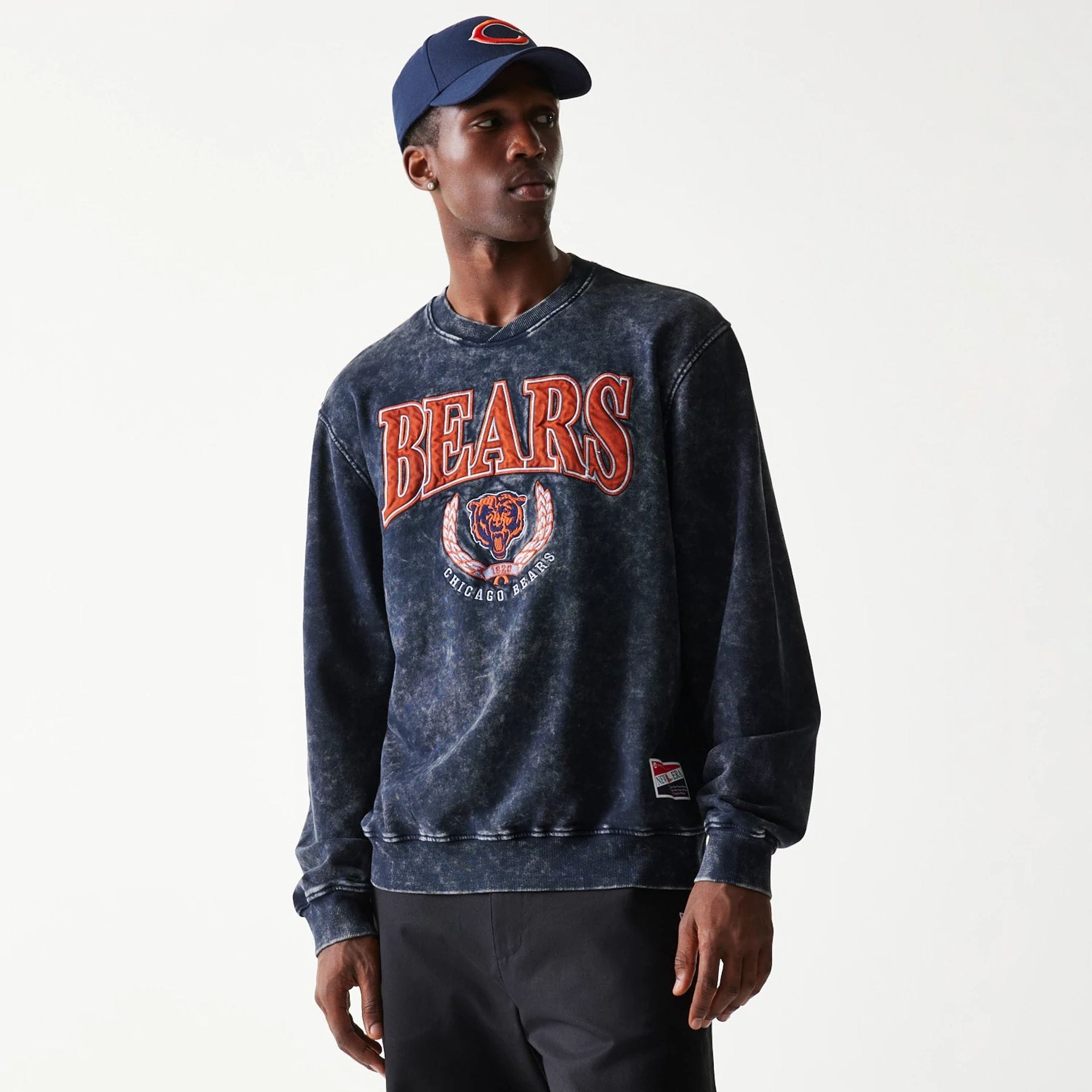 The model is wearing this NFL Chicago Bears Crew Neck Sweater in navy. 1