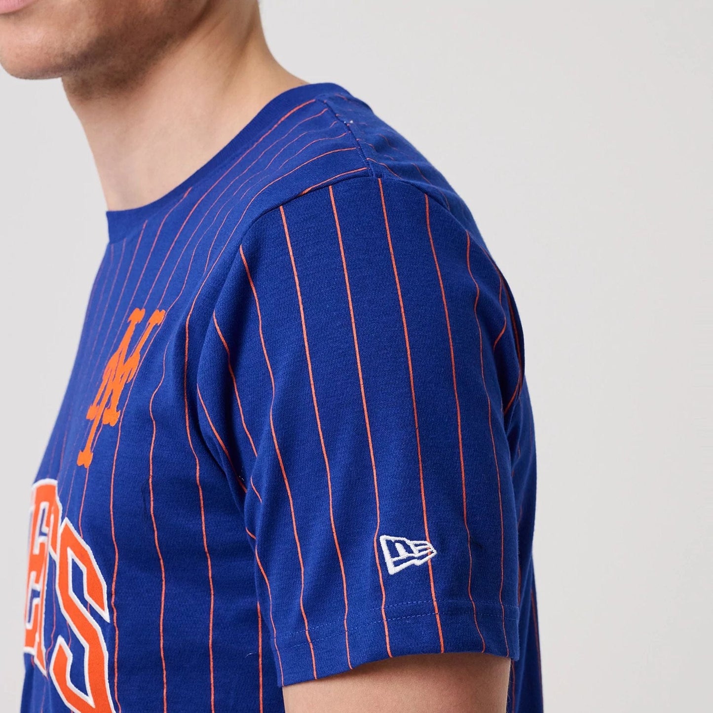 The model is wearing this MLB Pinstripe New York Mets T-Shirt in blue. 4